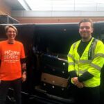 Home-Start IOW volunteer Sarah with a member of the Island Roads team loading up the van for the Tesco book stall